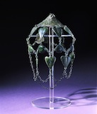 a headpiece of metal plates linked by chains