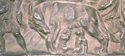Detail from a coin depicting she-wolf and Romulus and Remus.